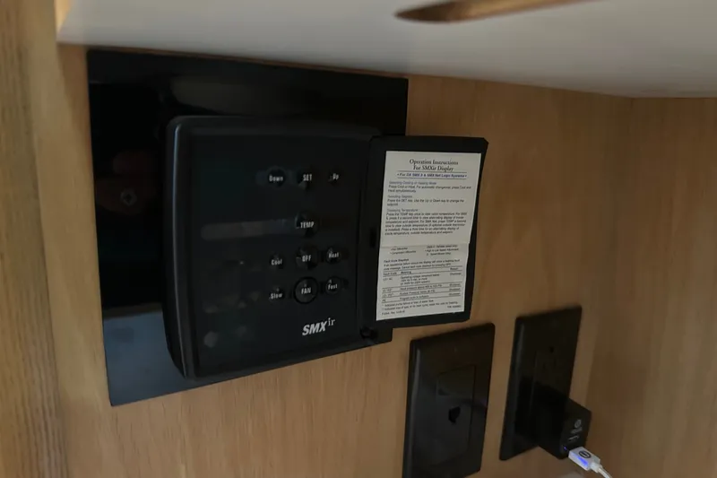 Slide: The Image of Control panel inside 1997 Tiara Yachts 4000 Express, featuring SMXir display and operation instructions. - 24