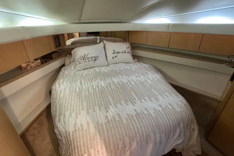 Slide: The Image of Cozy bedroom in 1997 Tiara Yachts 4000 Express with decorative pillows and soft lighting. - 22