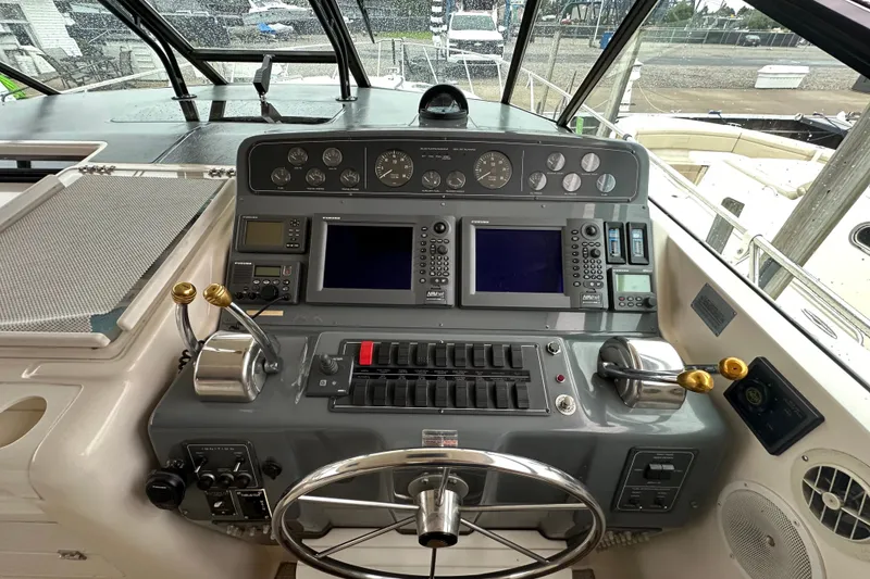 Slide: The Image of Cockpit of 1997 Tiara Yachts 4000 Express with navigation controls and steering wheel. - 11