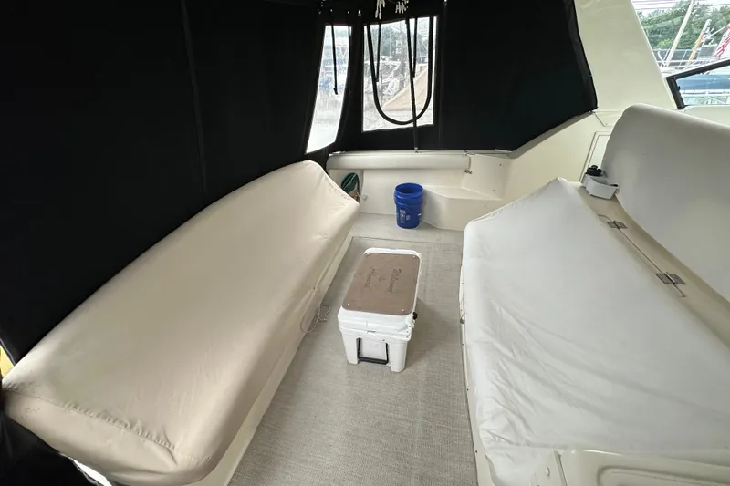 Slide: The Image of 1997 Tiara Yachts 4000 Express interior with seating and cooler. - 13