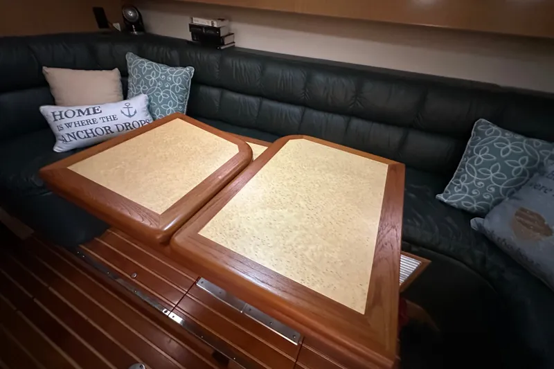 Slide: The Image of Luxurious interior of 1997 Tiara Yachts 4000 Express with elegant wood table and cushions. - 34
