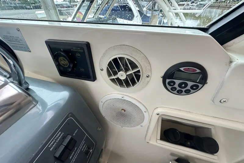 Slide: The Image of Control panel of a 1997 Tiara Yachts 4000 Express boat, featuring various instruments. - 38