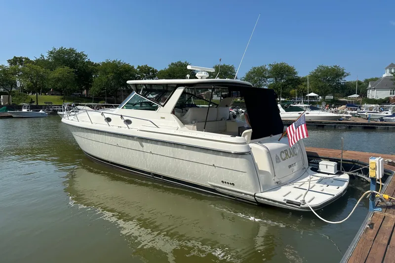 Slide: The Image of 1997 Tiara Yachts 4000 Express docked, featuring sleek design and American flag. - 4