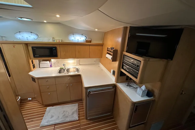 Slide: The Image of Interior of 1997 Tiara Yachts 4000 Express, featuring a modern kitchen and entertainment area. - 20