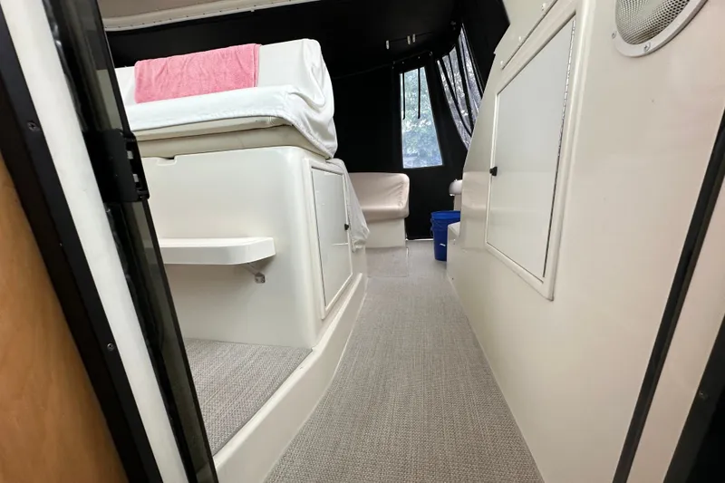 Slide: The Image of Interior view of a 1997 Tiara Yachts 4000 Express, featuring seating and storage. - 43