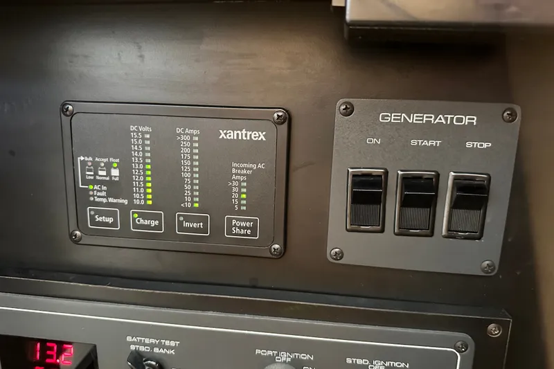 Slide: The Image of Control panel of a 1997 Tiara Yachts 4000 Express, featuring Xantrex and generator switches. - 40