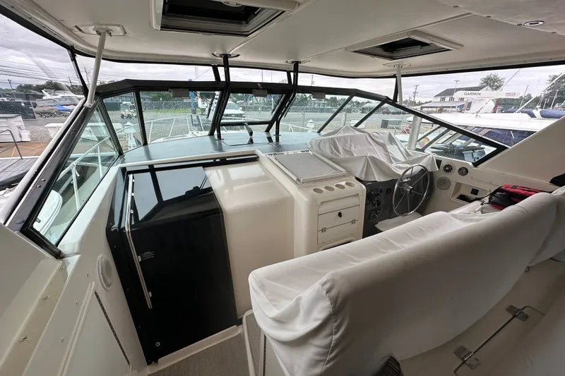 Slide: The Image of 1997 Tiara Yachts 4000 Express cockpit with covered seating and steering wheel. - 14