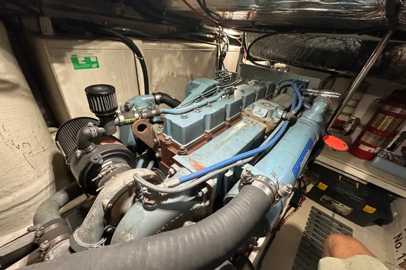 Slide: The Image of Engine room of a 1997 Tiara Yachts 4000 Express, showcasing mechanical components and wiring. - 52