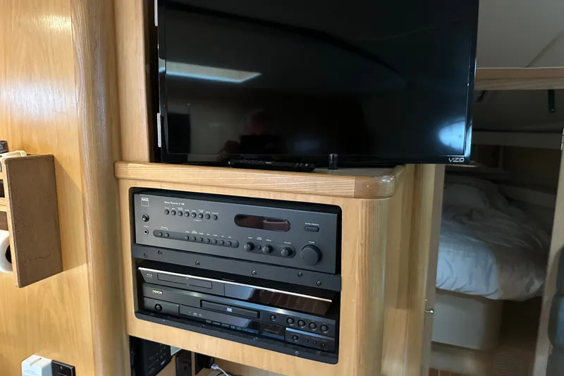 Slide: The Image of Entertainment system in 1997 Tiara Yachts 4000 Express, featuring a TV and audio equipment. - 23