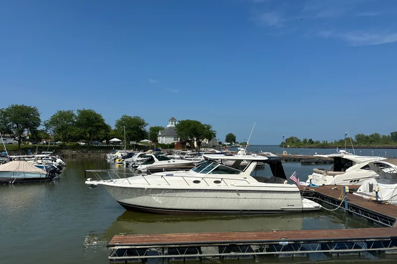 Slide: The Image of 1997 Tiara Yachts 4000 Express docked at a marina under clear blue skies. - 2