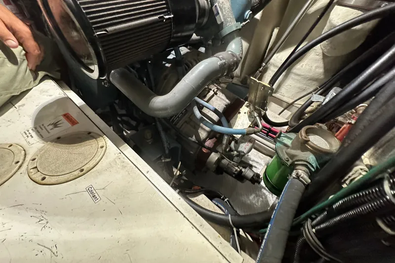 Slide: The Image of Engine compartment of a 1997 Tiara Yachts 4000 Express, showcasing mechanical components and wiring. - 53