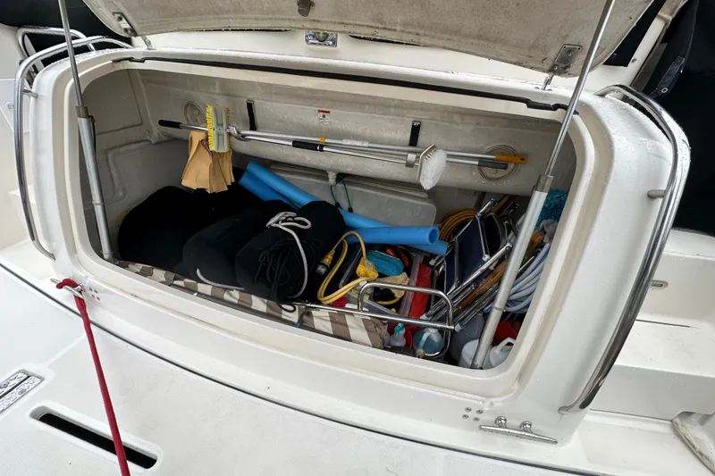 Slide: The Image of Storage compartment of a 1997 Tiara Yachts 4000 Express filled with boating equipment. - 15