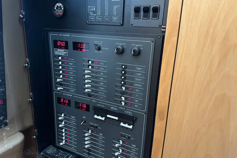 Slide: The Image of Control panel of a 1997 Tiara Yachts 4000 Express, featuring AC and DC power switches. - 41
