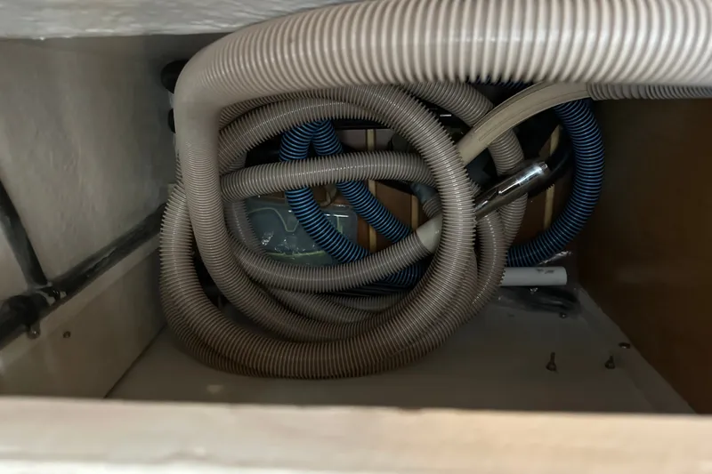 Slide: The Image of Coiled hoses inside a 1997 Tiara Yachts 4000 Express compartment. - 42