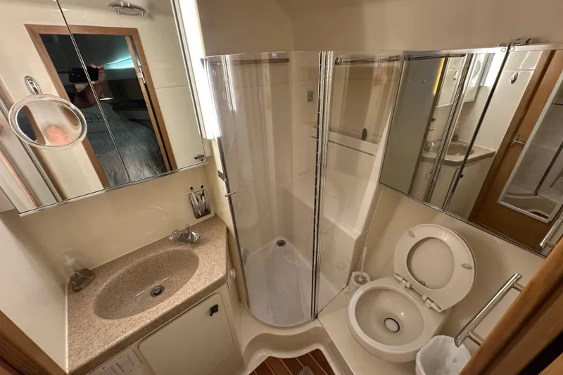 Slide: The Image of Bathroom interior of 1997 Tiara Yachts 4000 Express, featuring shower, sink, and toilet. - 28