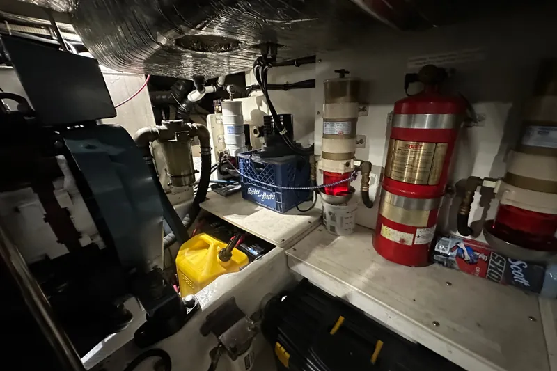 Slide: The Image of Engine room of 1997 Tiara Yachts 4000 Express with equipment and fire extinguishers. - 49
