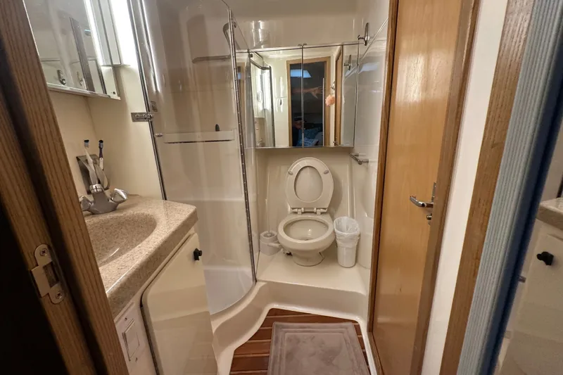 Slide: The Image of Bathroom interior of a 1997 Tiara Yachts 4000 Express, featuring a toilet and sink. - 29