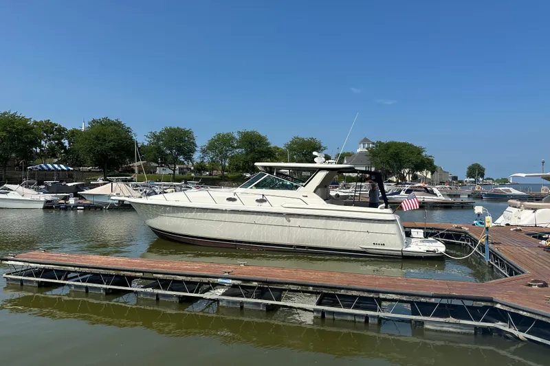Slide: The Image of 1997 Tiara Yachts 4000 Express docked at a marina on a sunny day. - 3