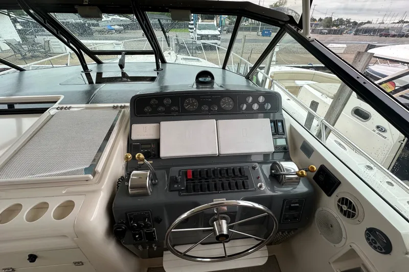 Slide: The Image of 1997 Tiara Yachts 4000 Express helm with steering wheel and control panel. - 10