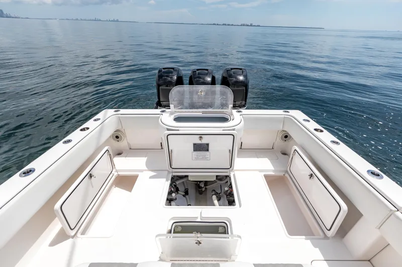 Slide: The Image of 2021 Invincible 39 Open Fisherman boat with spacious deck and triple engines on calm water. - 55