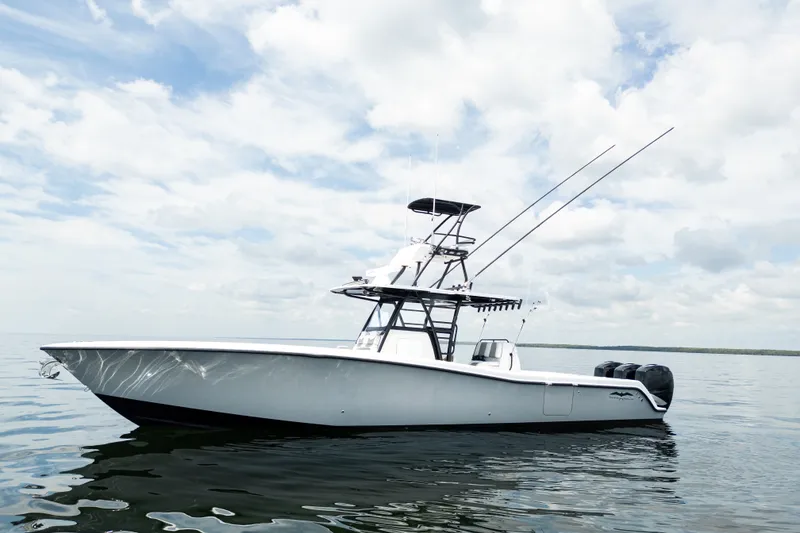 Slide: The Image of 2021 Invincible 39 Open Fisherman boat on calm water under cloudy sky. - 4