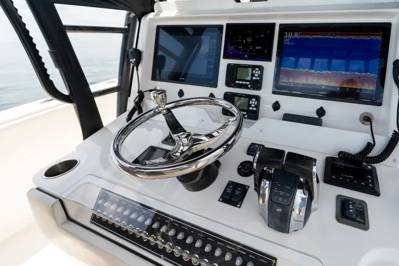 Slide: The Image of Helm of 2021 Invincible 39 Open Fisherman with advanced navigation displays and controls. - 12