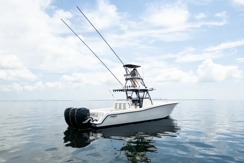 Slide: The Image of 2021 Invincible 39 Open Fisherman boat on calm water under a cloudy sky. - 1