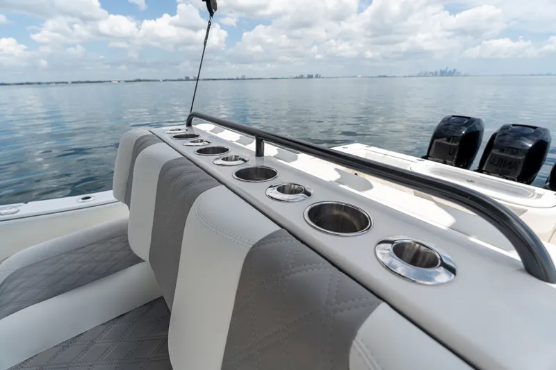 Slide: The Image of 2021 Invincible 39 Open Fisherman boat interior with cup holders and ocean view. - 51