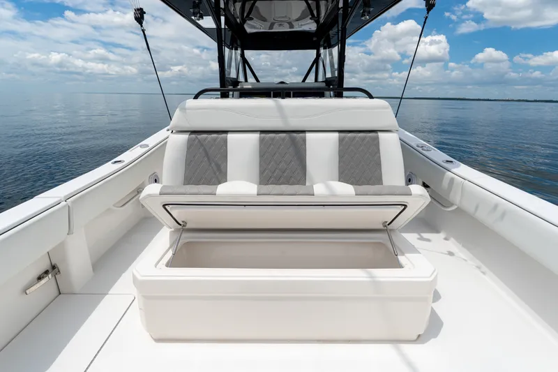 Slide: The Image of 2021 Invincible 39 Open Fisherman boat with open storage compartment, calm sea background. - 27