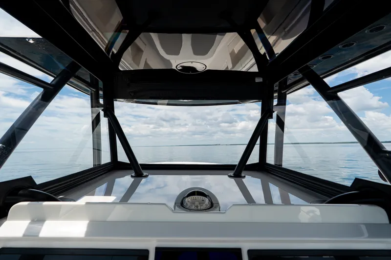 Slide: The Image of Interior view of 2021 Invincible 39 Open Fisherman boat, showcasing helm and ocean horizon. - 32