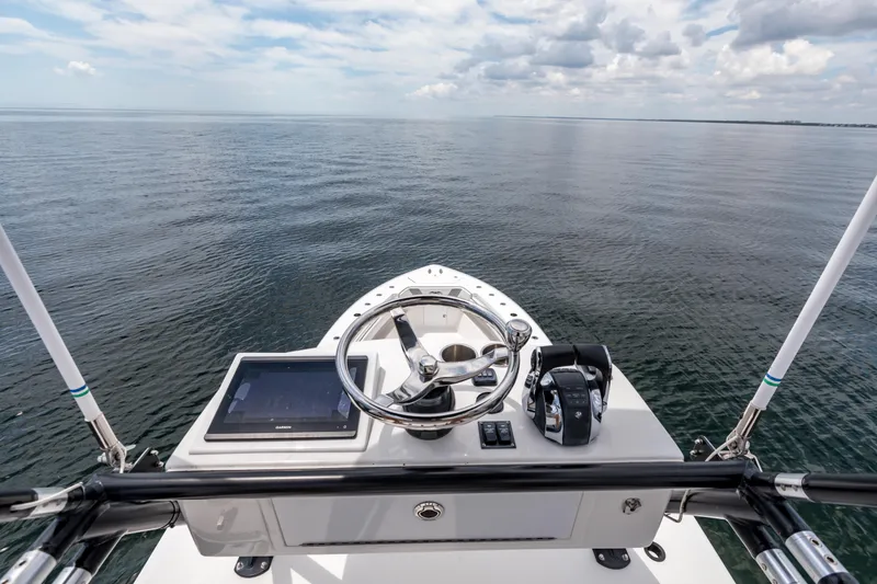 Slide: The Image of 2021 Invincible 39 Open Fisherman helm with ocean view, featuring modern controls and steering. - 59