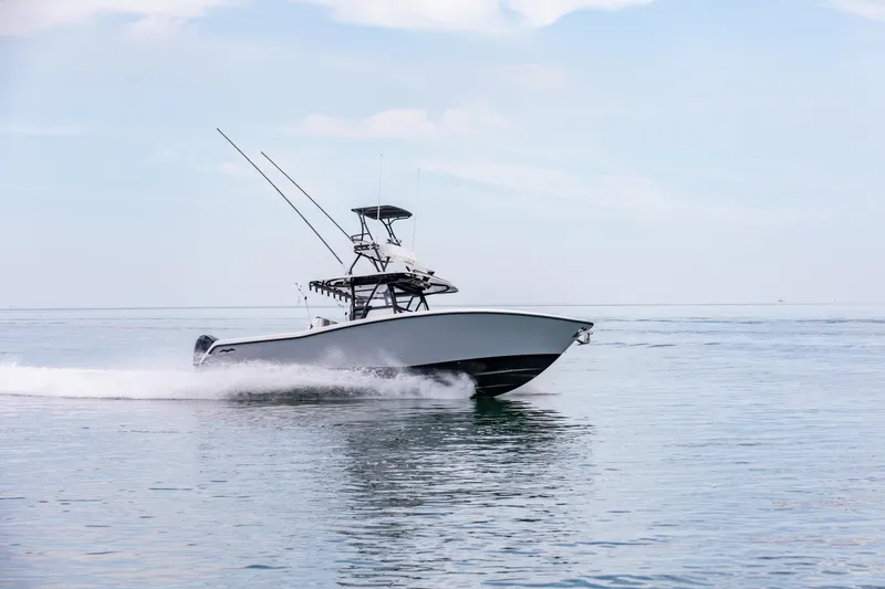 Slide: The Image of 2021 Invincible 39 Open Fisherman boat cruising on calm ocean waters. - 64