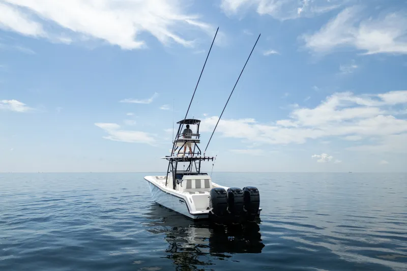 Slide: The Image of 2021 Invincible 39 Open Fisherman boat on calm ocean under blue sky. - 8