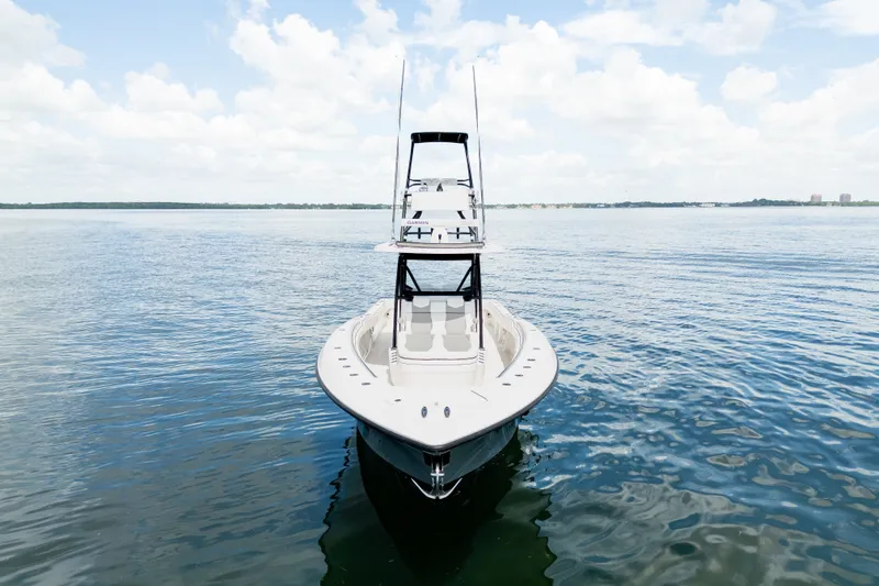 Slide: The Image of 2021 Invincible 39 Open Fisherman boat on calm water under a cloudy sky. - 2