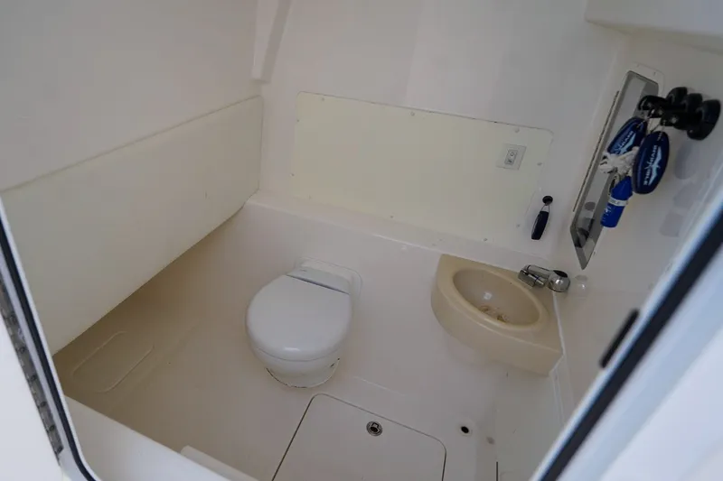 Slide: The Image of 2021 Invincible 39 Open Fisherman boat bathroom with toilet and sink. - 38