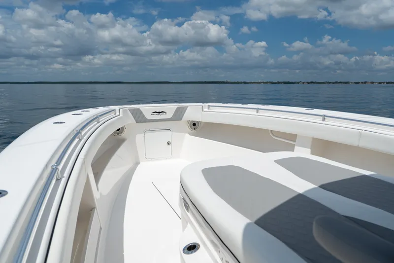 Slide: The Image of 2021 Invincible 39 Open Fisherman boat on calm water under a cloudy sky. - 21