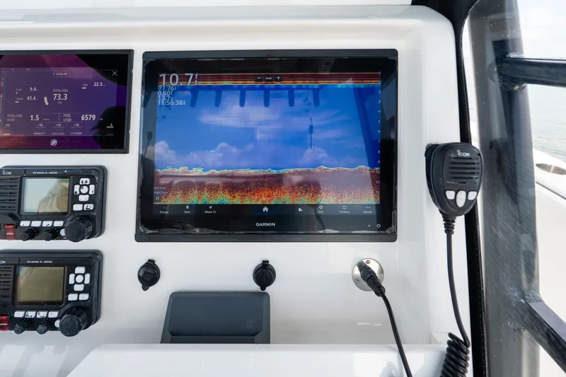 Slide: The Image of Console of 2021 Invincible 39 Open Fisherman with Garmin display and communication devices. - 40