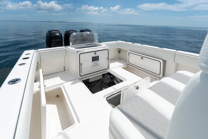 Slide: The Image of 2021 Invincible 39 Open Fisherman boat interior with storage compartments and ocean view. - 22