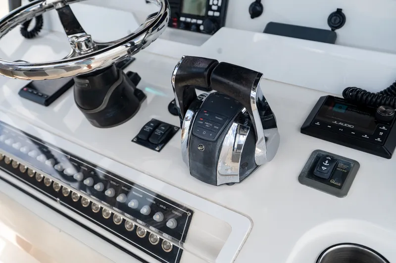 Slide: The Image of Control panel of 2021 Invincible 39 Open Fisherman boat with steering wheel and throttle. - 39