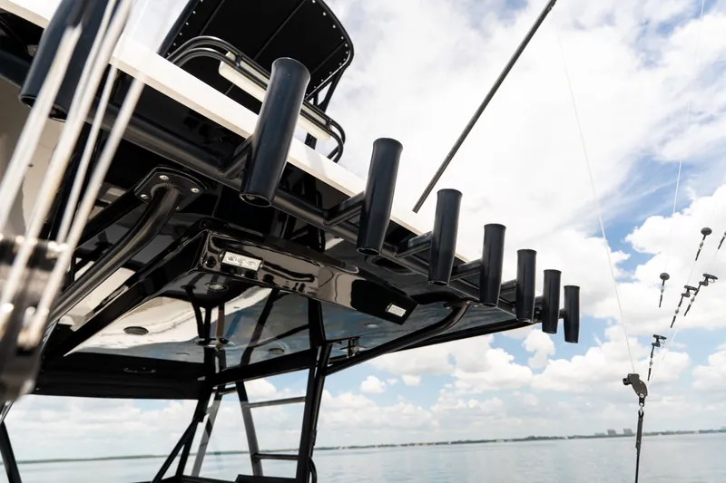Slide: The Image of 2021 Invincible 39 Open Fisherman boat with rod holders against a cloudy sky. - 29