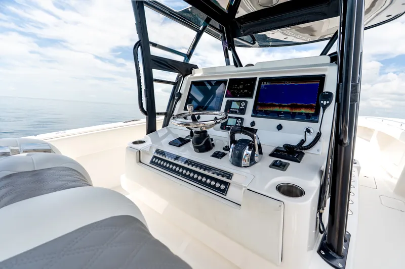 Slide: The Image of 2021 Invincible 39 Open Fisherman boat cockpit with advanced navigation systems and controls. - 44