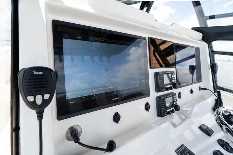 Slide: The Image of Control panel of 2021 Invincible 39 Open Fisherman with navigation screens and communication devices. - 42