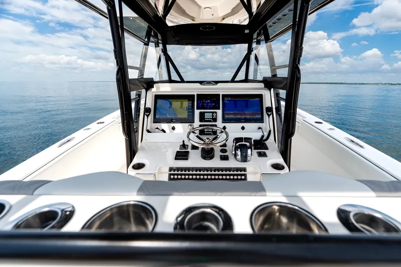 Slide: The Image of Cockpit view of 2021 Invincible 39 Open Fisherman boat on calm water. - 48