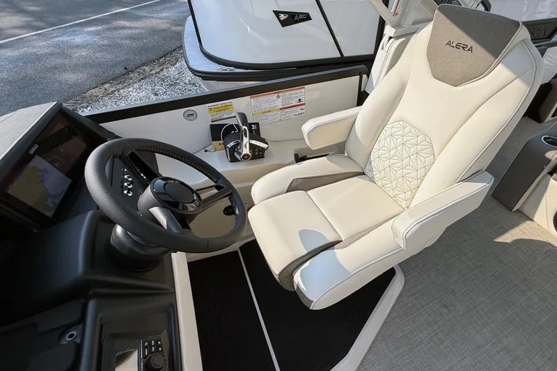 Slide: The Image of 2027 Alera M25L boat interior with luxury captain's chair and steering console. - 8