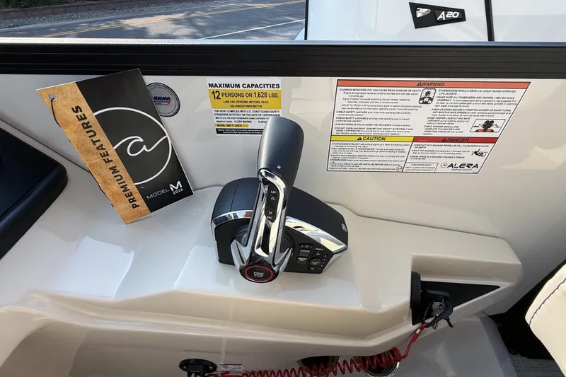 Slide: The Image of Control panel of Alera M25L 2027 boat with premium features booklet and safety warnings. - 10