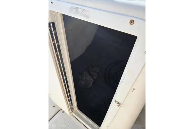 Slide: The Image of Open storage compartment on a 2011 Yamaha Boats 242 Limited. - 11