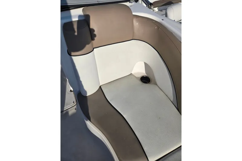 Slide: The Image of 2011 Yamaha Boats 242 Limited interior seating with beige and white upholstery. - 13