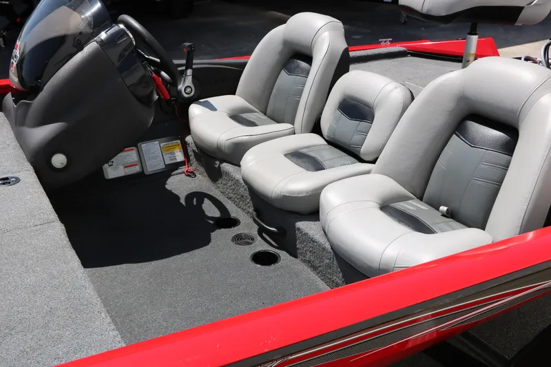 Slide: The Image of 2018 Tracker Pro Team 175 TXW boat interior with gray seating and steering console. - 16