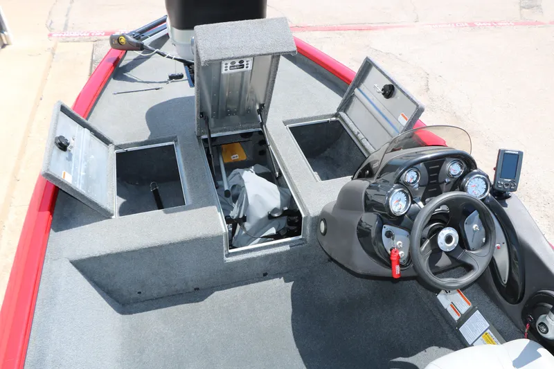 Slide: The Image of 2018 Tracker Pro Team 175 TXW boat interior with open storage compartments and control panel. - 28