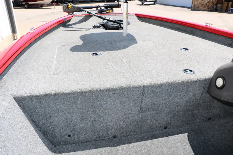 Slide: The Image of 2018 Tracker Pro Team 175 TXW boat deck with gray carpet and red trim. - 31